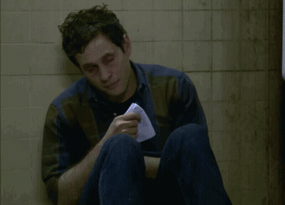 A Man Sitting On The Floor With A Napkin In His Hand And The Words I Think I Might Be Coming Down GIF