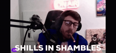 A Man Smoking A Cigar In Front Of A Microphone With The Words " Shills In Shambles " Written On The Bottom GIF