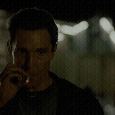 A Man Smoking A Cigarette In The Dark GIF