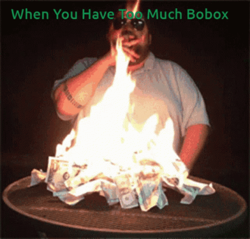 A Man Smoking A Cigarette Next To A Pile Of Money On Fire GIF
