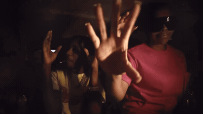 A Man Smoking A Cigarette Wearing A Shirt That Says ' Chicago ' On It GIF