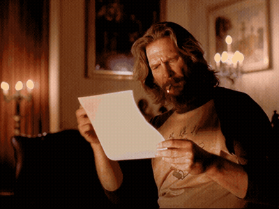 A Man Smoking A Cigarette While Reading A Letter GIF
