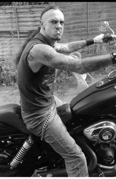A Man Smoking A Cigarette While Riding A Motorcycle GIF
