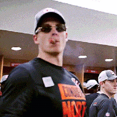 A Man Smoking A Cigarette While Wearing Sunglasses And A Chicago T-Shirt GIF