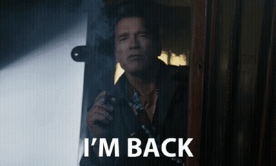 A Man Smoking A Cigarette With The Words I 'M Back Written Below Him GIF