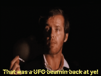 A Man Smoking A Cigarette With The Words " That Was A Ufo Beamin Back At Ye " Behind Him GIF