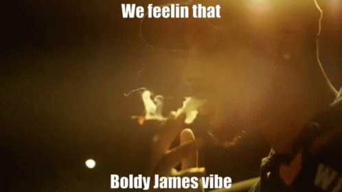 A Man Smoking A Cigarette With The Words We Feelin That Boldy James Vibe GIF