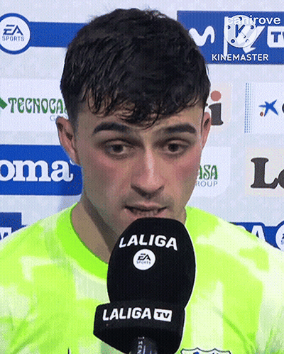 A Man Speaking Into A Laliga Tv Microphone While Wearing A Neon Green Shirt GIF