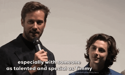 A Man Speaking Into A Microphone Next To Another Man With The Words " Especially With Someone As Talented And Special As GIF