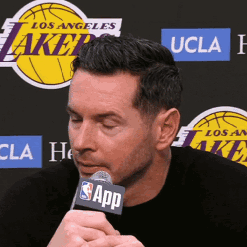 A Man Speaking Into A Microphone With The Word App On It GIF