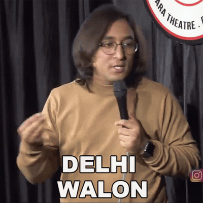 A Man Speaking Into A Microphone With The Words Delhi Walon Above Him GIF