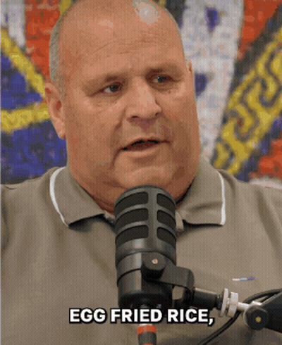 A Man Speaking Into A Microphone With The Words Egg Fried Rice GIF