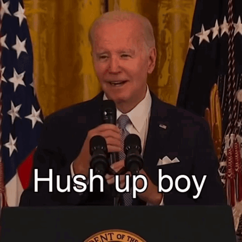 A Man Speaking Into A Microphone With The Words Hush Up Boy Written On The Bottom GIF