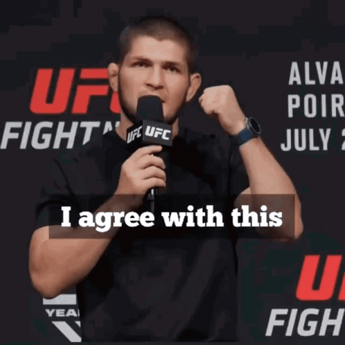 A Man Speaking Into A Microphone With The Words I Agree With This Above Him GIF