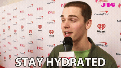 A Man Speaking Into A Microphone With The Words " Stay Hydrated " On The Bottom GIF