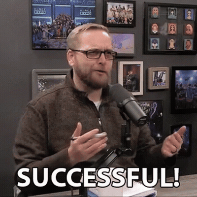 A Man Speaking Into A Microphone With The Words Successful Written On The Bottom GIF