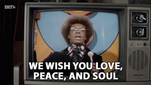 A Man Speaking Into A Microphone With The Words " We Wish You Love Peace And Soul " On The Screen GIF
