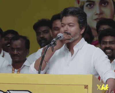 A Man Speaking Into A Microphone With Xhk Written On A Yellow Box GIF