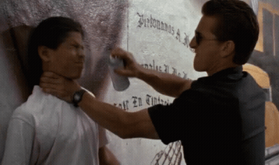 A Man Spraying Another Man 'S Neck With A Can Of Spray GIF