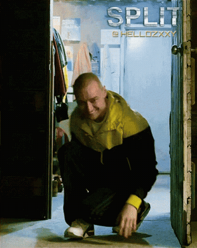 A Man Squatting In Front Of A Sign That Says Split On It GIF