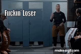 A Man Standing In A Bathroom With The Words Fuckin ' Loser Written On The Bottom GIF