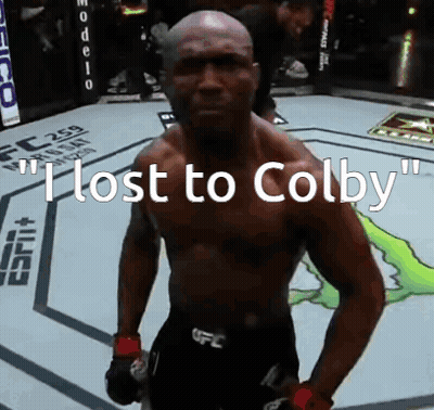 A Man Standing In A Boxing Ring With The Words " I Lost To Colby " On The Bottom GIF