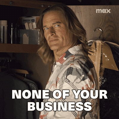 A Man Standing In A Closet With The Words None Of Your Business GIF