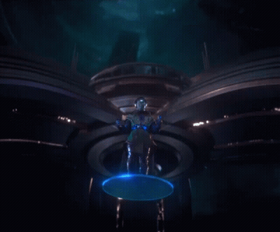 A Man Standing In A Dark Room With Blue Lights Coming Out Of His Hands GIF