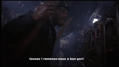 A Man Standing In A Dark Room With The Words " C'est Un Ordre " Written On The Bottom GIF