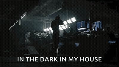 A Man Standing In A Dark Room With The Words In The Dark In My House Above Him GIF