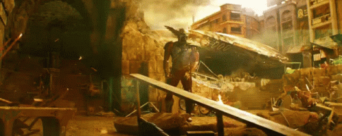A Man Standing In A Destroyed City With A Sign That Says ' 00000 ' GIF