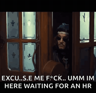 A Man Standing In A Doorway With The Words " Excuse Me F * Ck Umm Im Here Waiting For An Hr " Above Him GIF