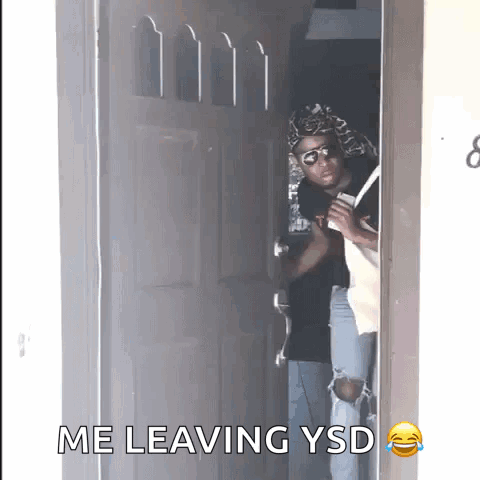 A Man Standing In A Doorway With The Words " Me Leaving Ysd " On The Bottom GIF