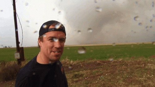 A Man Standing In A Field With A Hat That Says ' U.s. Army ' On It GIF