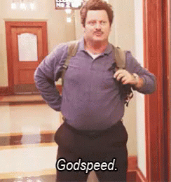 A Man Standing In A Hallway With His Hands On His Hips And Says Godspeed GIF