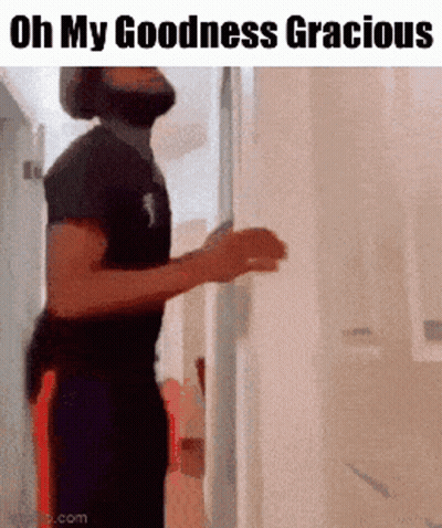A Man Standing In A Hallway With The Words Oh My Goodness Gracious GIF
