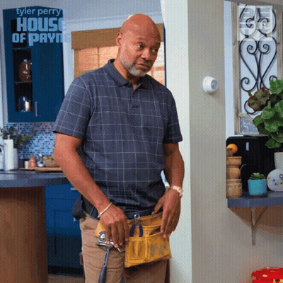 A Man Standing In A Kitchen With A House Of Payne Logo On The Wall GIF