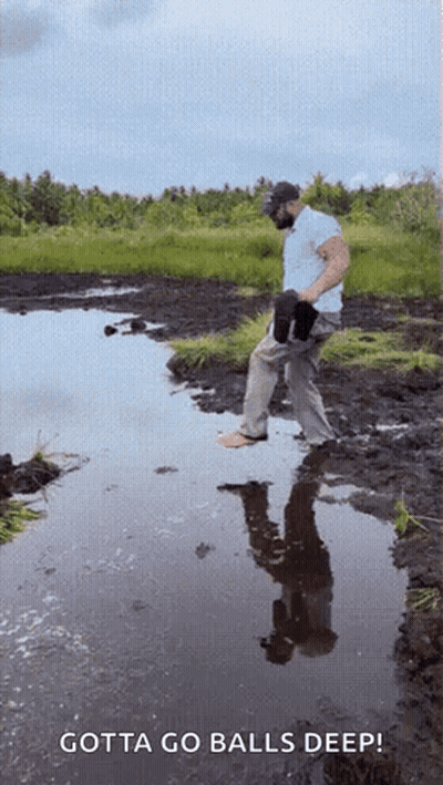 A Man Standing In A Muddy Puddle With The Words Gotta Go Balls Deep GIF