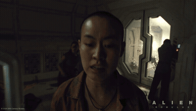 A Man Standing In A Room With The Word Alien On The Bottom GIF
