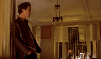A Man Standing In A Room With The Words " Don 'T Tease Me " Written Above Him GIF