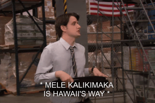 A Man Standing In A Warehouse With The Words Mele Kaliimaka Is Hawaii 'S Way GIF