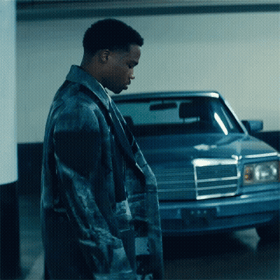 A Man Standing In Front Of A Blue Mercedes GIF