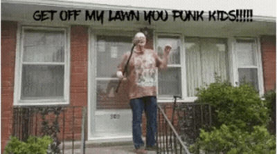 A Man Standing In Front Of A Brick House With The Words Get Off My Lawn You Punk Kids Written Above Him GIF