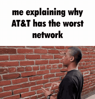 A Man Standing In Front Of A Brick Wall With The Words " Me Explaining Why At & T Has The Worst Network " GIF