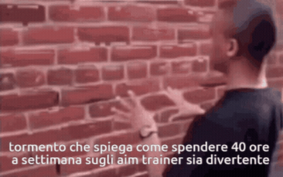 A Man Standing In Front Of A Brick Wall With The Words Tormento Che Spiega GIF