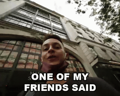A Man Standing In Front Of A Building With The Words One Of My Friends Said GIF