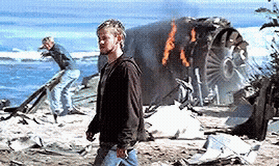 A Man Standing In Front Of A Burning Plane GIF