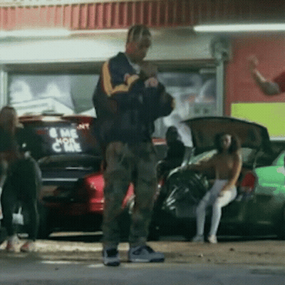 A Man Standing In Front Of A Car That Says Come On GIF