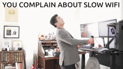 A Man Standing In Front Of A Computer With The Words You Complain About Slow Wifi GIF
