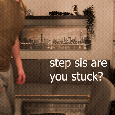 A Man Standing In Front Of A Couch With The Words " Step Sis Are You Stuck " Written On It GIF